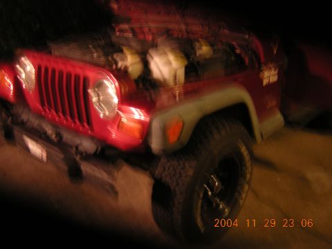 1984 Chevrolet Blazer - A red Jeep Wrangler is parked with its hood open, showing the engine compartment.