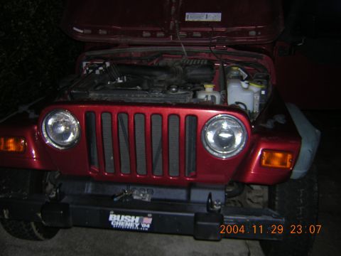 1984 Chevrolet Blazer - Front view of a red Jeep Wrangler with its hood open, revealing the engine compartment.