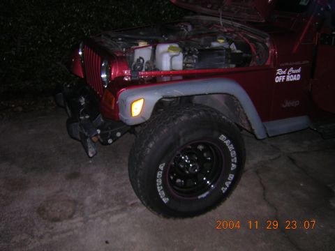 1984 Chevrolet Blazer - Red Jeep Wrangler with hood open, "Red Creek OFF ROAD" sticker visible on the fender.