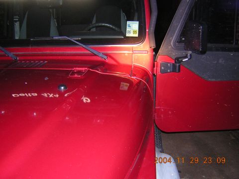 1984 Chevrolet Blazer - A red Jeep Wrangler is shown with its driver's door open. A sticker is visible on the windshield.