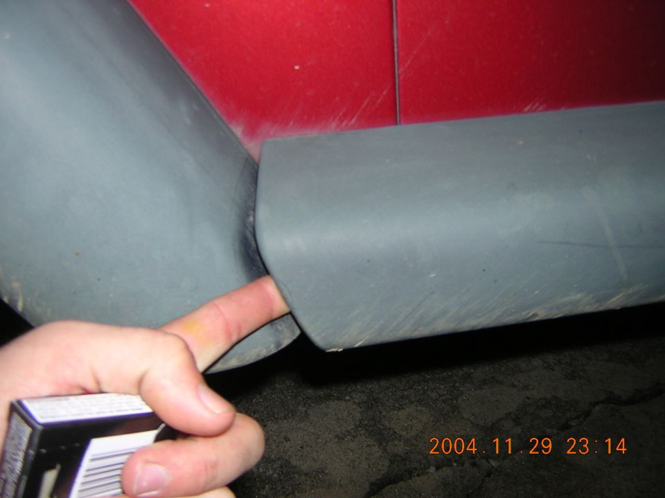 Close-up of gray and red interior paneling, possibly a car door or seat