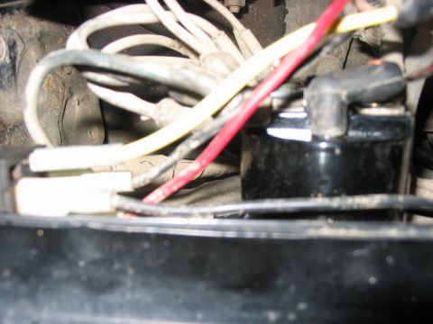 1988 Ford Bronco - A close-up view of a vehicle's engine compartment shows an ignition coil and associated wiring.