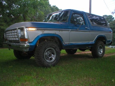 1978 Ford Bronco - This 1978 Ford Bronco is shown from a three-quarter front angle, with its blue and silver paint scheme visible.