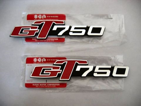 1985 Ford LTD Crown Victoria - Pair of Suzuki GT750 emblems, each in its own plastic packaging.