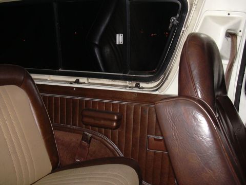 1978 Ford Bronco - The interior of a 1978 Ford Bronco shows its classic design with brown and tan upholstery.