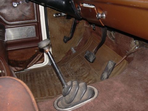 1978 Ford Bronco - Interior view of a 1978 Ford Bronco, showing the floor shifter and pedals.