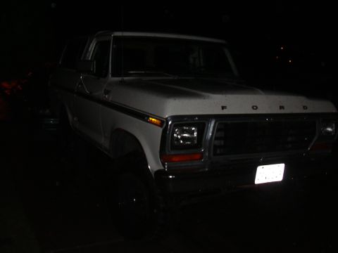 1978 Ford Bronco - A white 1978 Ford Bronco is viewed from a three-quarter front angle at night.