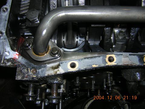 1984 Chevrolet Blazer - This image shows a close-up view of an engine's internal components, specifically the oil pump pickup tube and crankshaft.