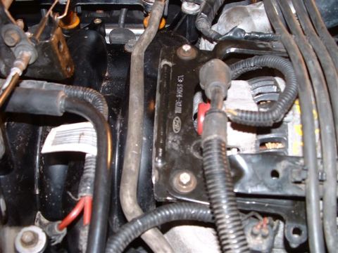 1996 Ford Crown Victoria - Engine bay components including alternator and wiring harness. A part number is visible on a bracket.