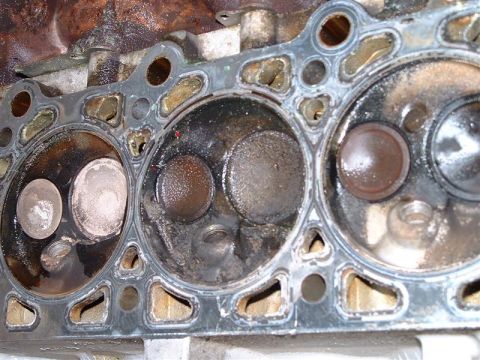 1996 Ford Crown Victoria - Close-up of an engine cylinder head, likely removed for repair or inspection.