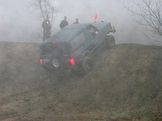 Dark green 1979 Ford Bronco climbing a dirt hill