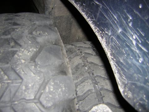 1995 Ford Bronco - This image shows the wheel well and tires of a vehicle, but lacks sufficient detail to identify the make or model.