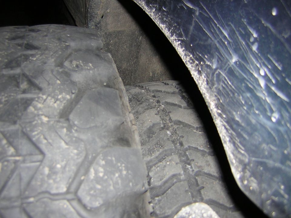 Close-up of two tires in a wheel well