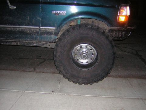 1995 Ford Bronco - Side view of a 1995 Ford Bronco, highlighting its fender and wheel assembly.