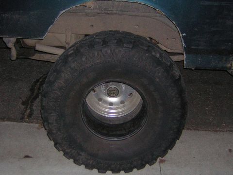 1995 Ford Bronco - The vehicle's tire and fender are visible in this close-up shot.