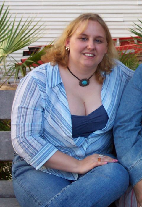 1992 Ford Bronco - A woman is pictured sitting outdoors on a bench, wearing a blue and white striped shirt and jeans.
