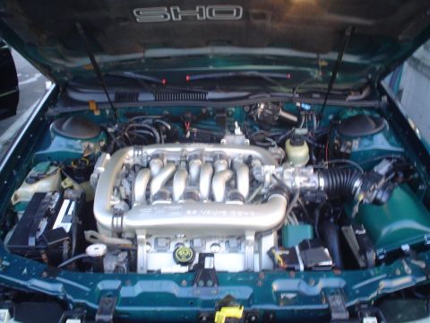 1993 Ford Taurus - Engine bay of a 1993 Ford Taurus SHO, showing the V6 engine and SHO badging.