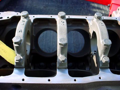 1973 Ford Ranchero - Close-up view of an engine block's crankshaft bearing saddles and bolts, with a yellow tag attached.