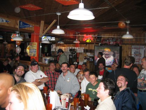2002 Ford Taurus - People gathered at tables in a bar, with sports memorabilia visible on the walls.