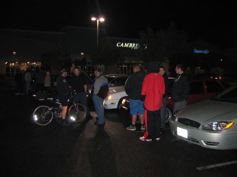 2002 Ford Taurus - A silver sedan is parked at night, showing its front end with visible headlights and a dented bumper.