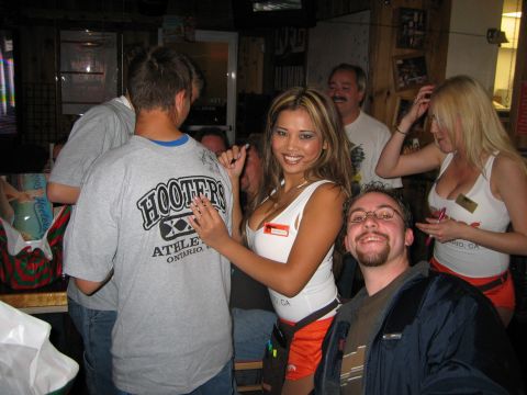 2002 Ford Taurus - A group of people are gathered inside a Hooters restaurant.