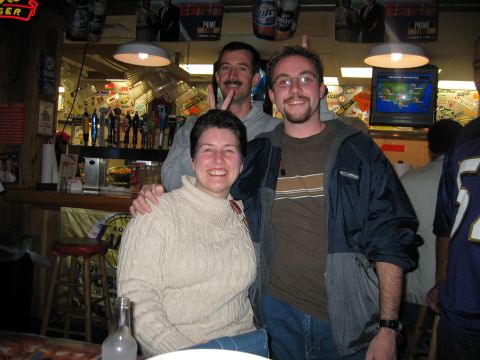 2002 Ford Taurus - A group of friends pose for a photo inside a bar, with beer taps and a television visible.