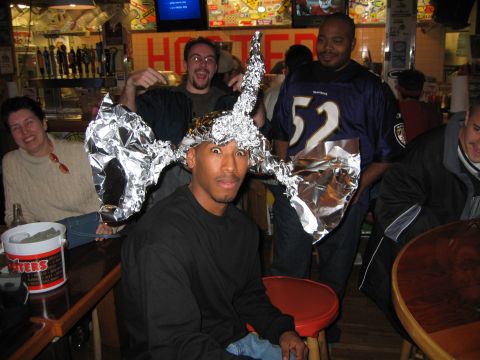 2002 Ford Taurus - Friends gather at a bar, sporting creative tinfoil headwear while one person wears a Baltimore Ravens jersey.
