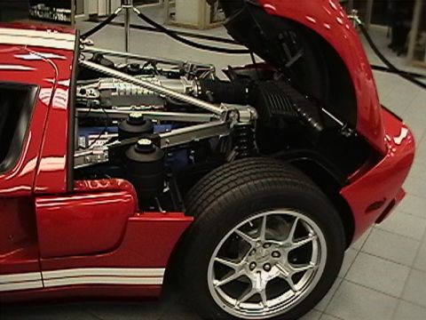 1991 Ford Taurus - Close-up view of a red sports car's engine compartment, revealing intricate mechanical details.