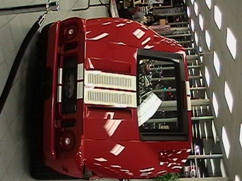 1991 Ford Taurus - Rear view of a red sports car with distinctive white vents on its deck.