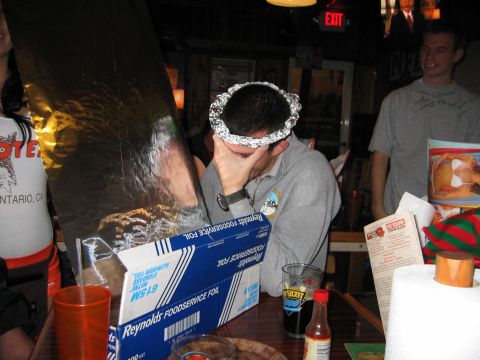 2002 Ford Taurus - People gathered around a table, one person wearing a foil crown, with food service foil prominently displayed.