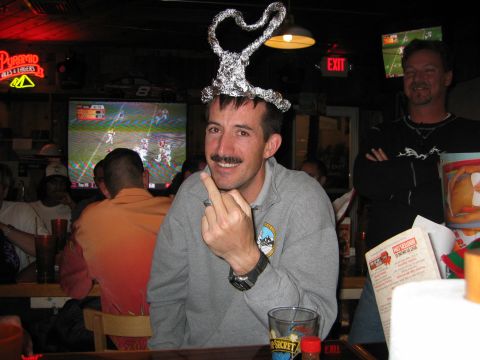 2002 Ford Taurus - Man wearing a tinfoil hat gives the middle finger while watching a football game in a bar.