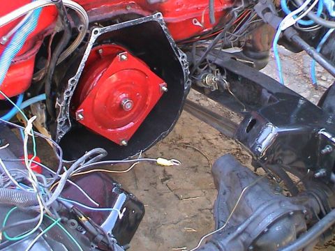 1979 Ford Bronco - Close-up view of engine and transmission parts with visible wiring and metal frame.