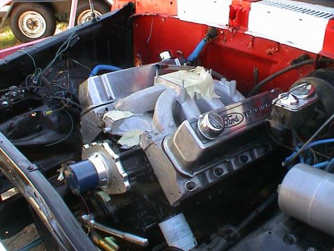 1979 Ford Bronco - Close-up of a Ford V8 engine with aftermarket valve covers, possibly undergoing maintenance or upgrade.