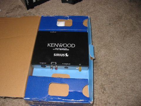 1988 Ford Bronco - A Kenwood Sirius car stereo unit is shown inside its original packaging.