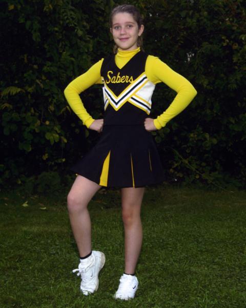 1991 Ford Bronco - A young cheerleader poses in her team uniform outdoors.