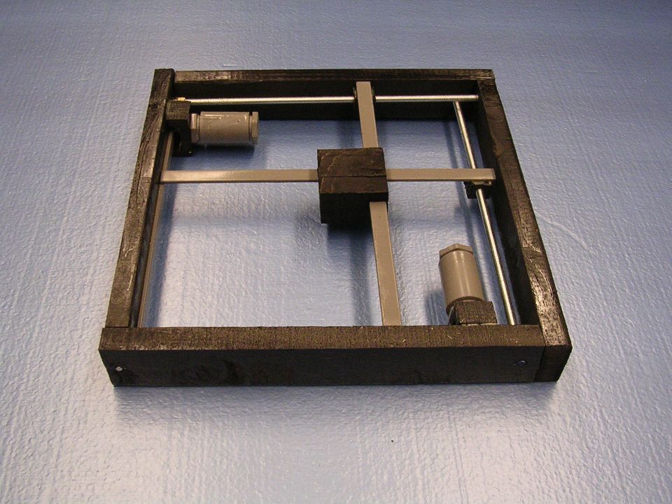 DIY CNC machine frame with wooden base, metal rods, and two stepper motors