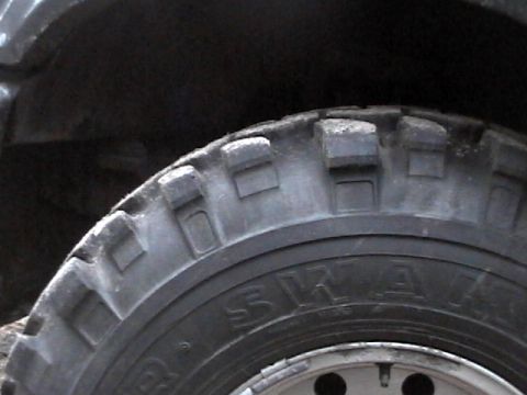 1995 Ford Bronco - A close-up view of a tire tread and sidewall, showing off-road capabilities.