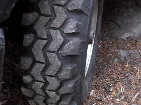 1995 Ford Bronco - The aggressive tread pattern of an off-road tire is visible in this close-up shot.
