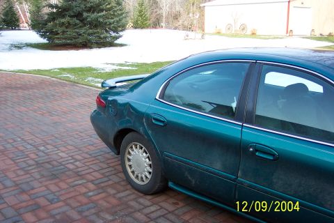 1996 Mercury Sable - Rear view of a teal 1996 Mercury Sable sedan, a subtle rear spoiler.