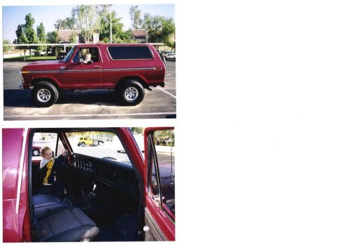 1978 Ford Bronco - A red 1978 Ford Bronco is shown from the side, with a child visible inside the interior.