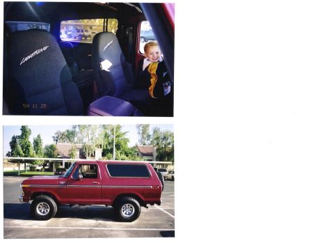 1978 Ford Bronco - Red 1978 Ford Bronco parked outside with a child in the back seat.