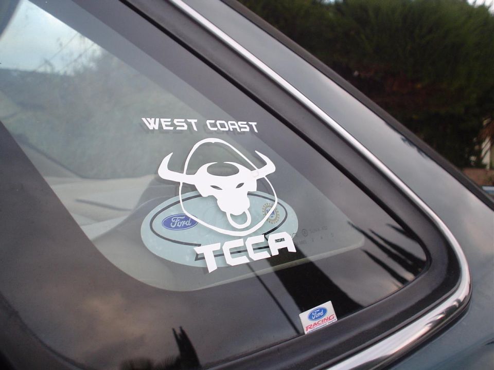 Car rear window with 'WEST COAST TCCA' and Ford Racing stickers