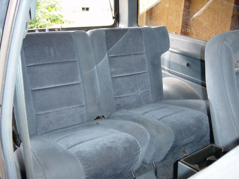 1993 Ford Bronco - The interior of the vehicle shows blue fabric seats and the rear passenger area.