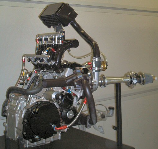 Engine assembly with turbocharger and intake manifold, mounted on a stand