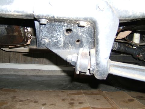 1978 Ford Bronco - Underside view of a vehicle's suspension system, focusing on a bracket and linkage.