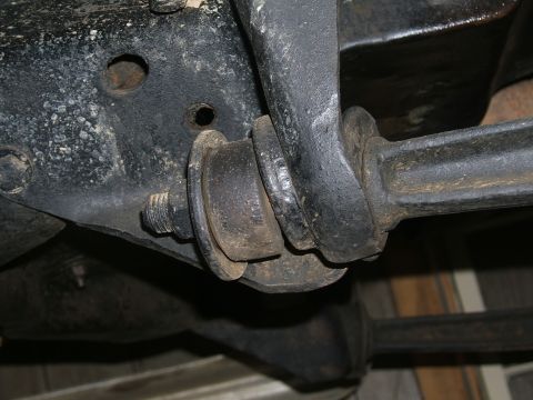 1978 Ford Bronco - Underside view of a vehicle's suspension system, showing a worn bushing and mounting hardware.