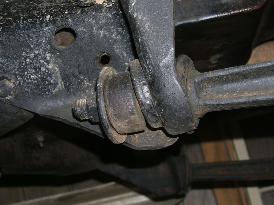 Close-up of a rusty suspension bushing and metal bracket