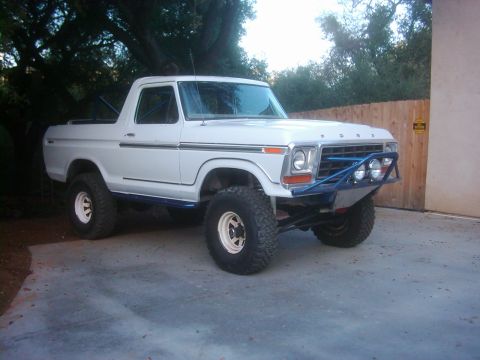 1978 Ford Bronco - This modified 1978 Ford Bronco features a custom blue bumper with auxiliary lights and aggressive off-road tires.