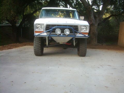1978 Ford Bronco - Front view of a 1978 Ford Bronco modified with a blue off-road bumper and spotlights.