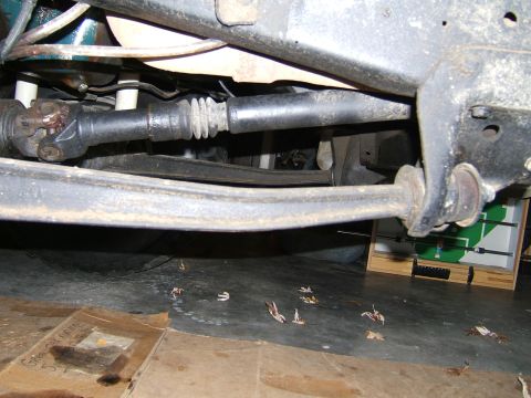 1978 Ford Bronco - Close-up of vehicle undercarriage components, including the driveshaft and suspension system.